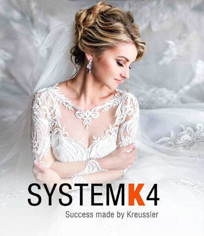 A bride in a white lace dress with her arms crossed sits against a light background. Text reads "SYSTEMK4 Success made by Kreussler.